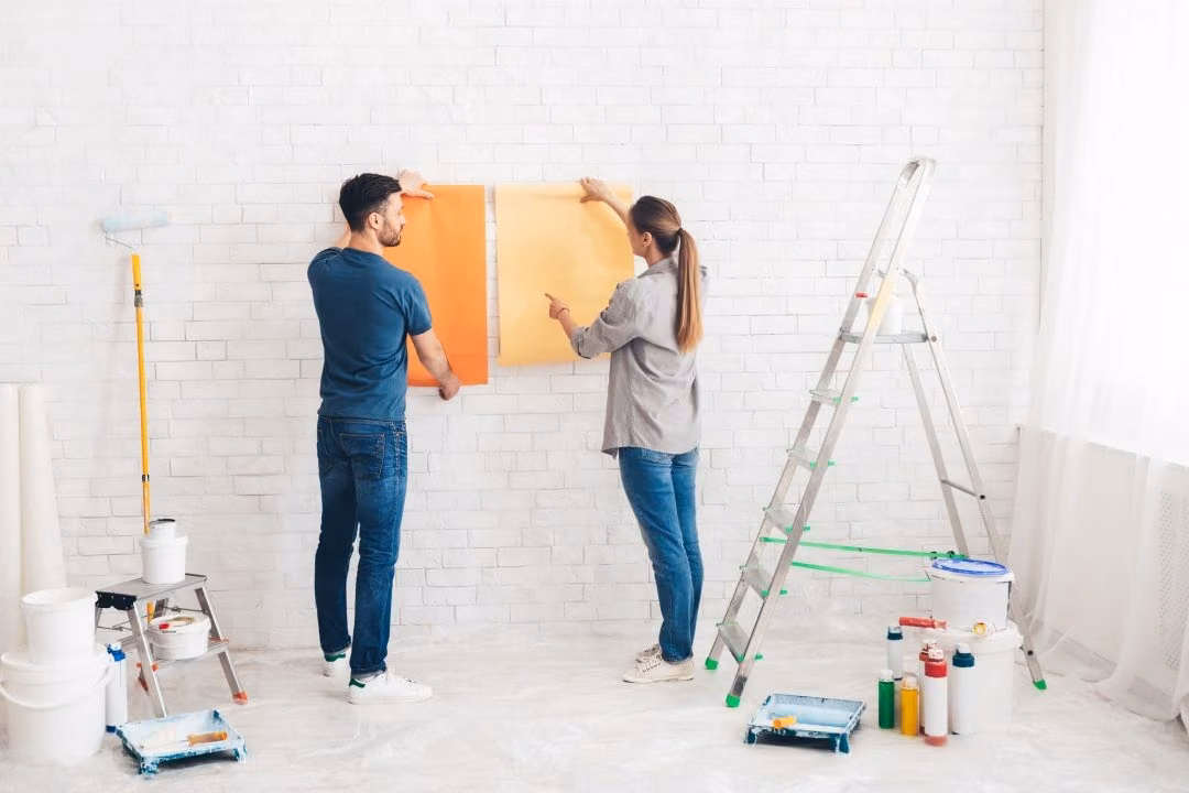 A couple considering paint colours for their home